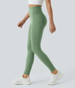 Side view of a model walking in Celeste L'Amour Kashmir high-waisted 7/8 leggings with side pockets